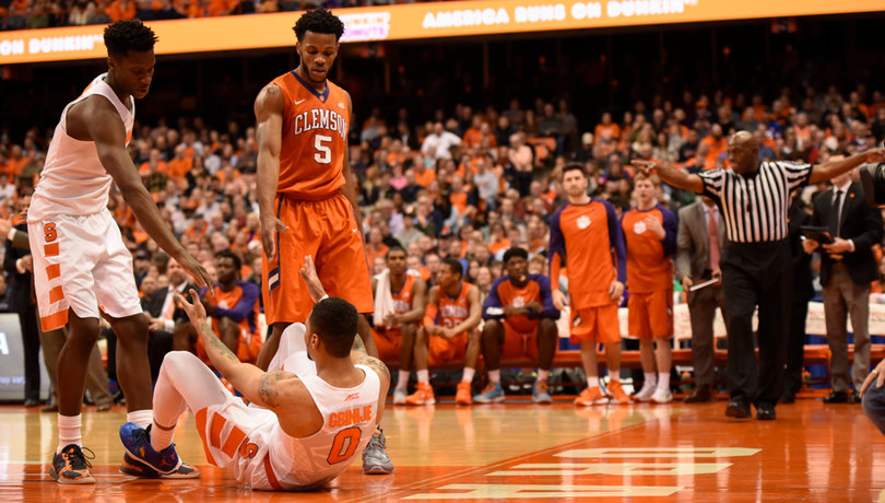 Gbinije is helped up by Syracuse forward Tyler Roberson and Blossomgame. Gbinije scored 22 points but had just one rebound.
