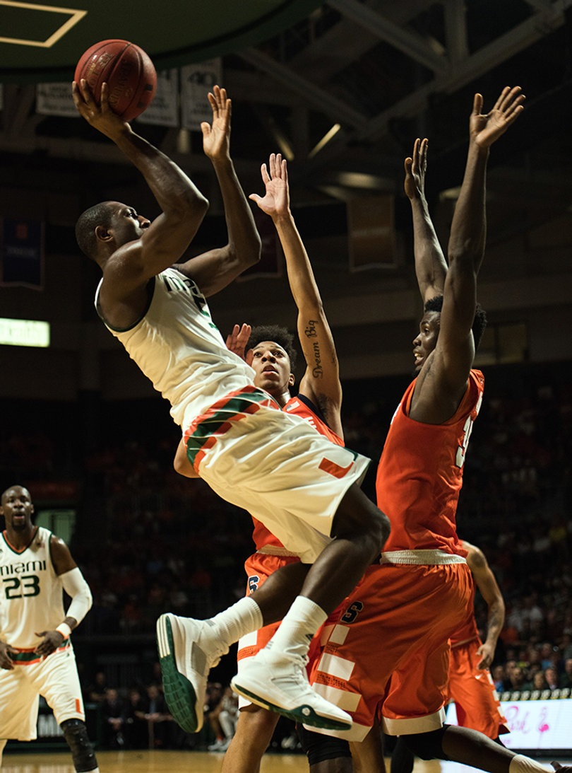 Miami guard Davon Reed rises above SU center Chinonso Obokoh and Richardson. Reed scored four points, while shooting 1-of-7 from the floor.