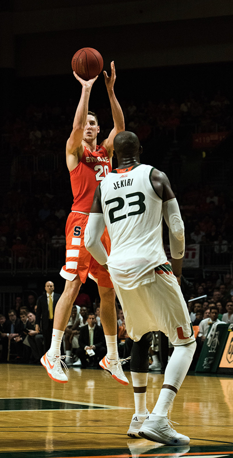 Tyler Lydon takes a jump shot over Miami center Tonye Jekiri. The SU forward took only four shots against the Hurricanes, but scored seven points and collected 10 rebounds. 