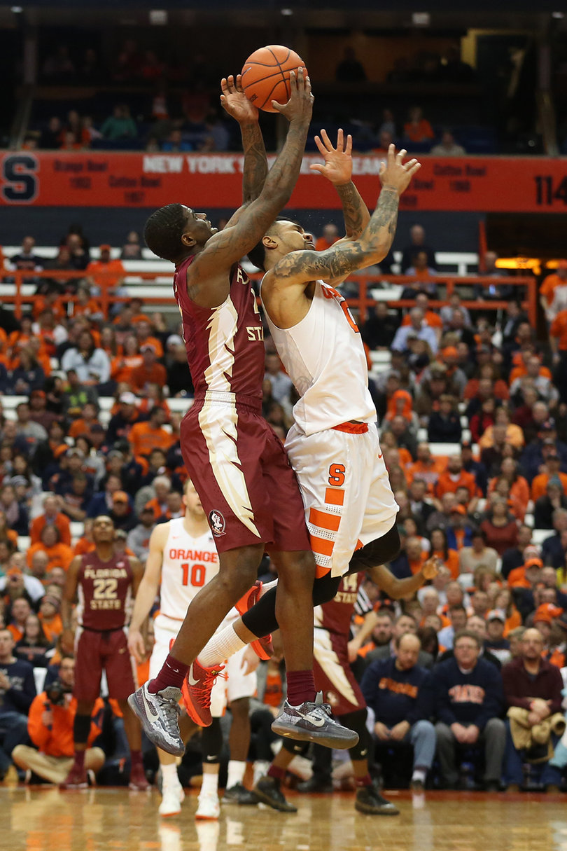 Gbinije gets tangled up with an FSU player while going up for a loose ball. 