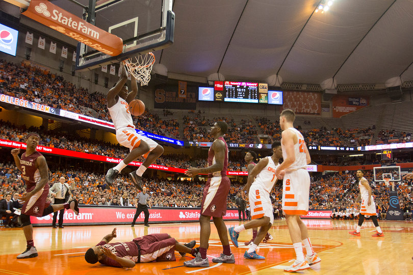 Tyler Roberson hangs on the rim after throwing down a dunk on Thursday night against FSU. He scored nine points.
