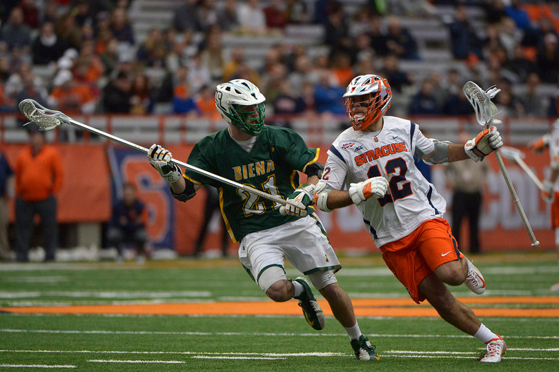 Syracuse midfielder Derek DeJoe brings the ball upfield while being guarded by Siena's Neil Gollogly. DeJoe had one goal on four shots.