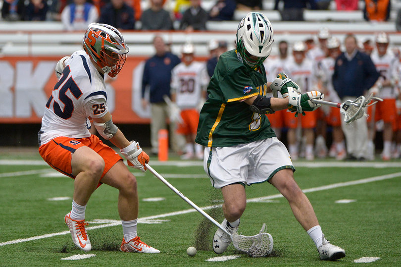 Syracuse long-stick midfielder Scott Firman competes with  a Siena player for a loose ball.