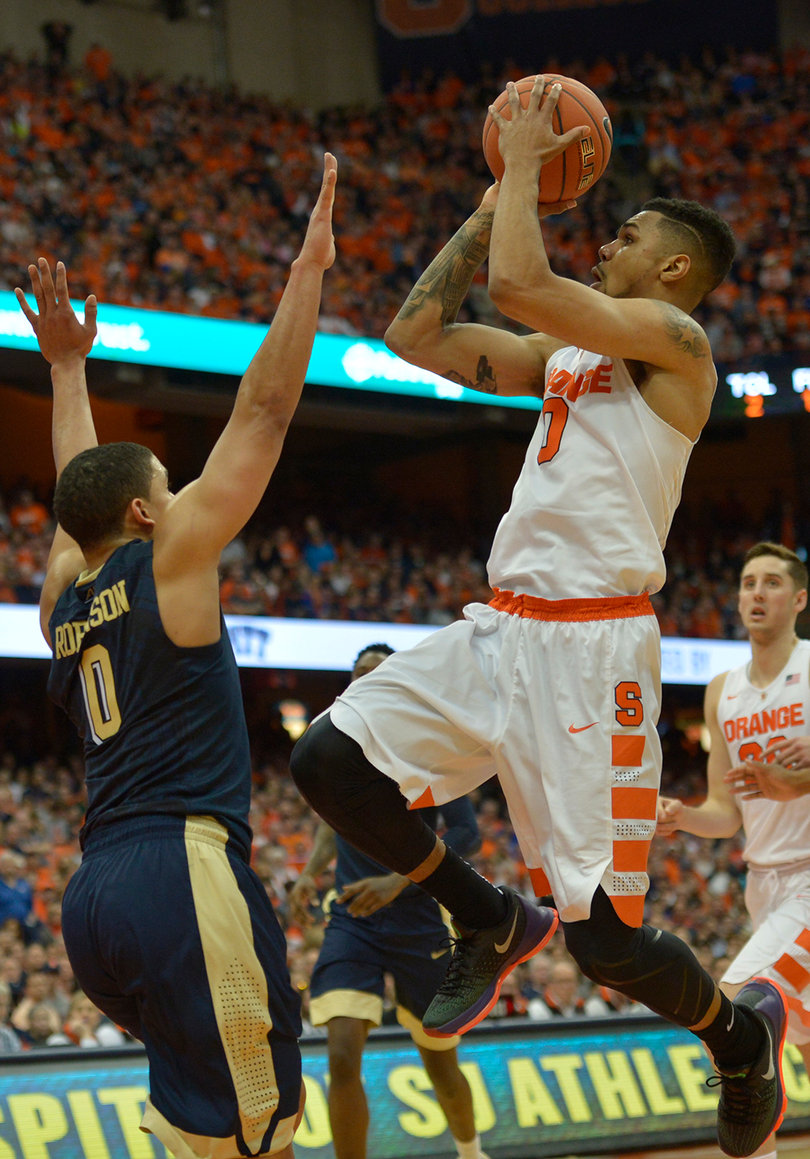 Gbinije lifts his right knee into the air while shooting a floater. Gbinije played 37 minutes. 