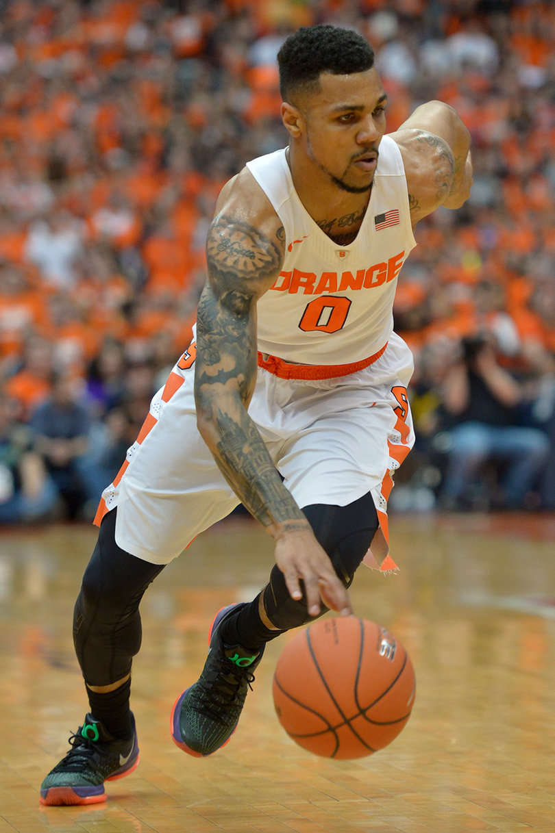 Gbinije dribbles the ball low to the ground with his right hand. The Orange's leading scorer on the season went 4-of-10 from the field.