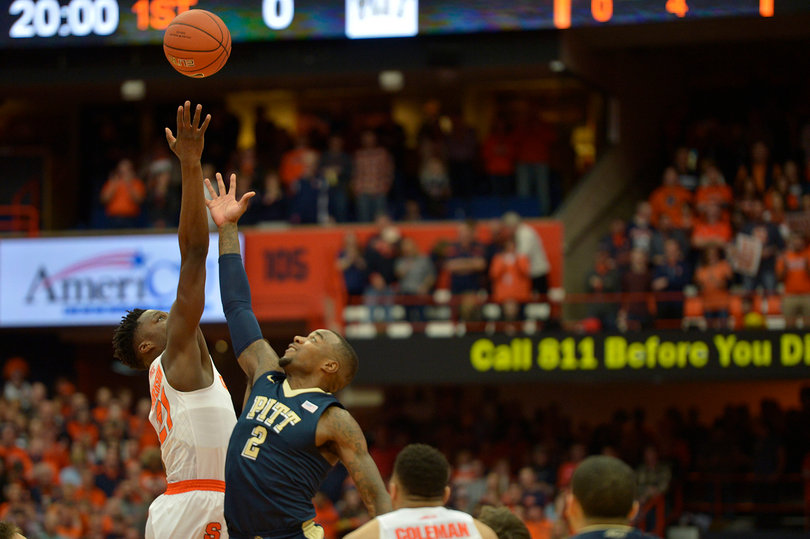 Roberson jumps with Pitt forward Michael Young, who scored eight points and grabbed 13 boards for the Panthers on Saturday. 