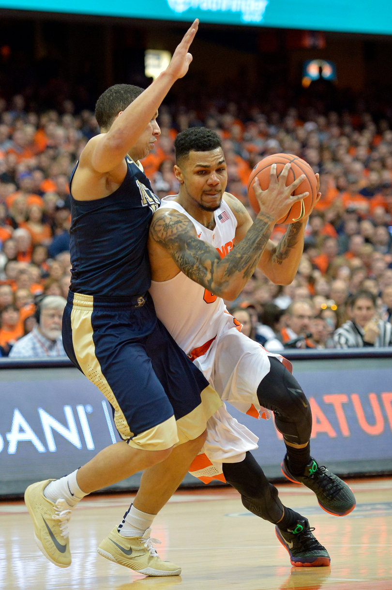 Gbinije protects the ball with both hands while trying to create an offensive opportunity.