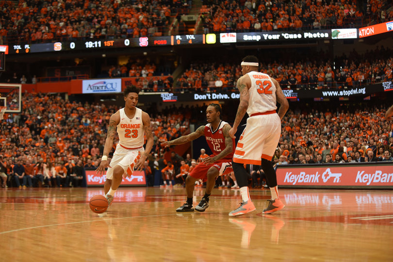 North Carolina State's leading scorer Anthony 'Cat' Barber guards Syracuse guard Malachi Richardson as Dajuan Coleman sets a pick. 