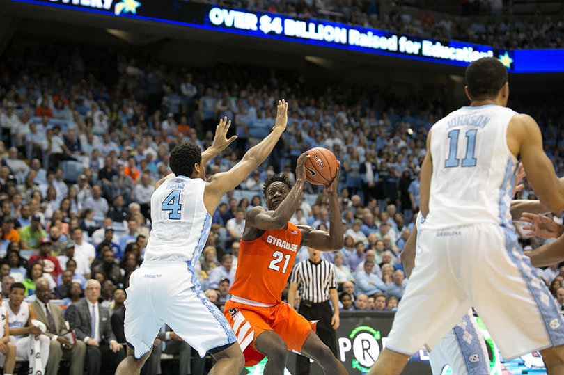 Tyler Roberson holds the ball with a defender closing down on him. 