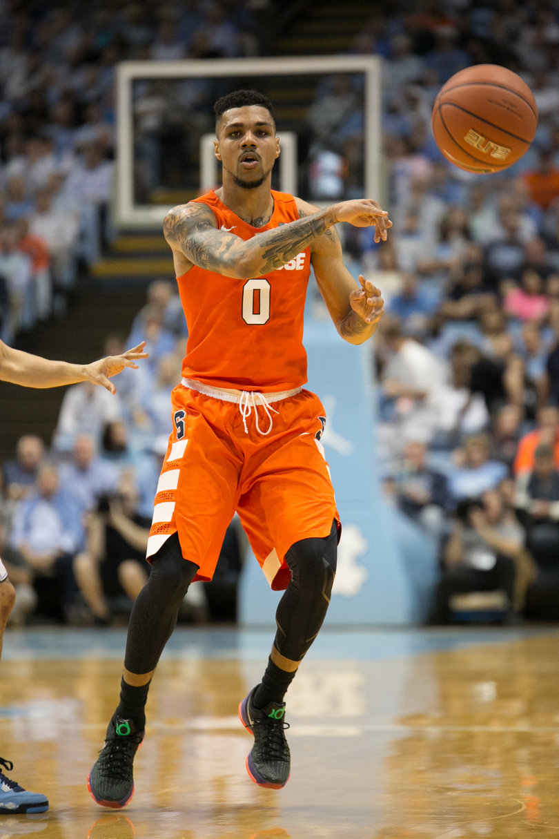 Gbinije dishes a pass beyond the outstretched arm of a North Carolina player. He had seven assists against the Tar Heels. 