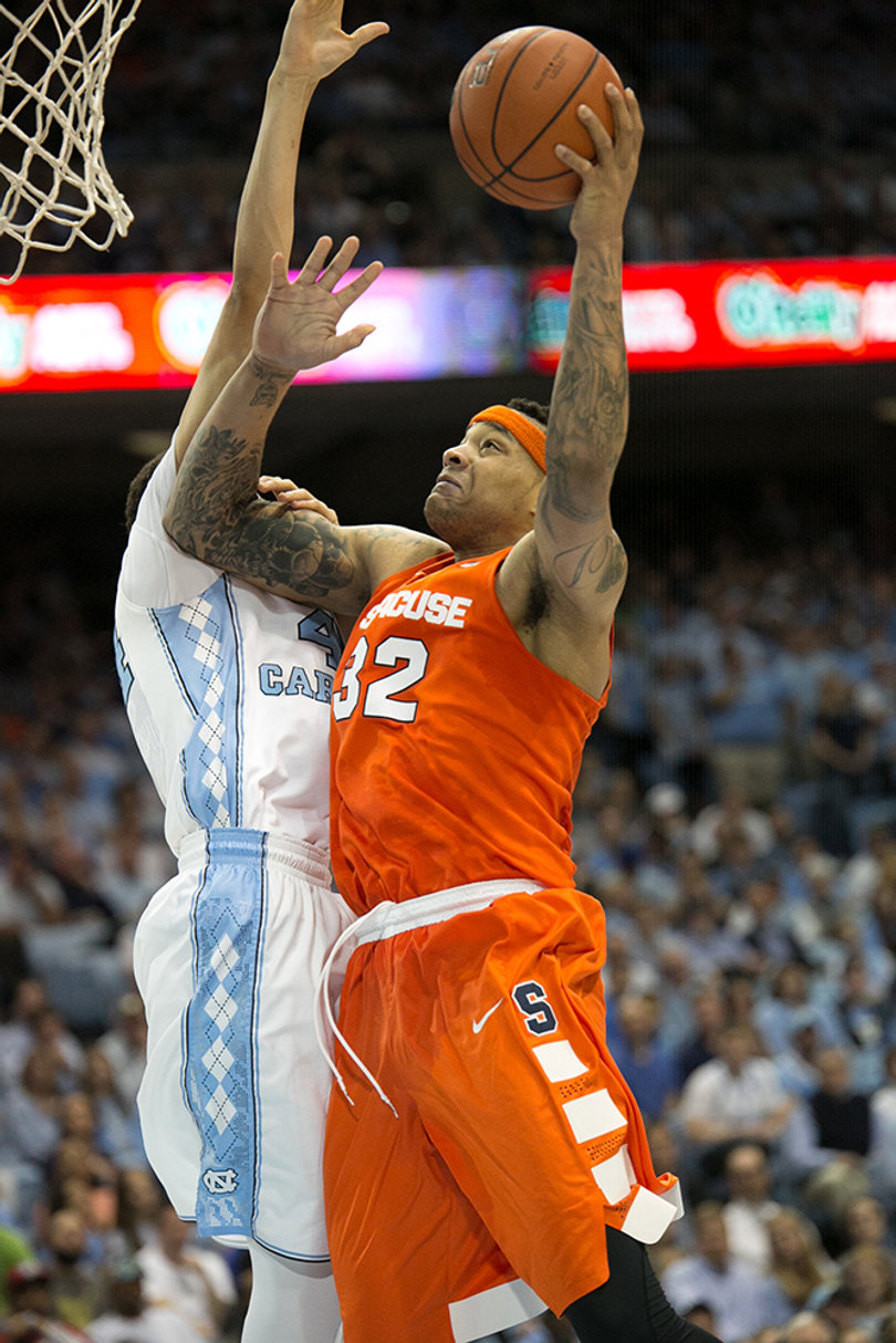 Syracuse center Dajuan Coleman attacks the basket in the first half.