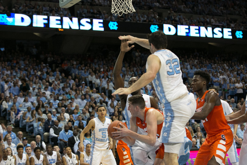 Lydon ducks under UNC forward Luke Maye, who tallied more rebounds (three) than points (one). 