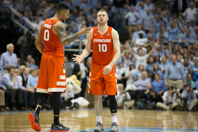 Cooney and Gbinije slap hands during Syracuse's matchup with the Tar Heels. Together they scored 31 points and assisted on eight buckets.  
