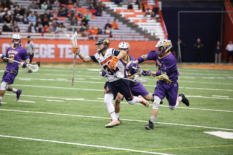 Syracuse's Tom Grimm avoids two Albany defenders. He picked up four ground balls on the day.