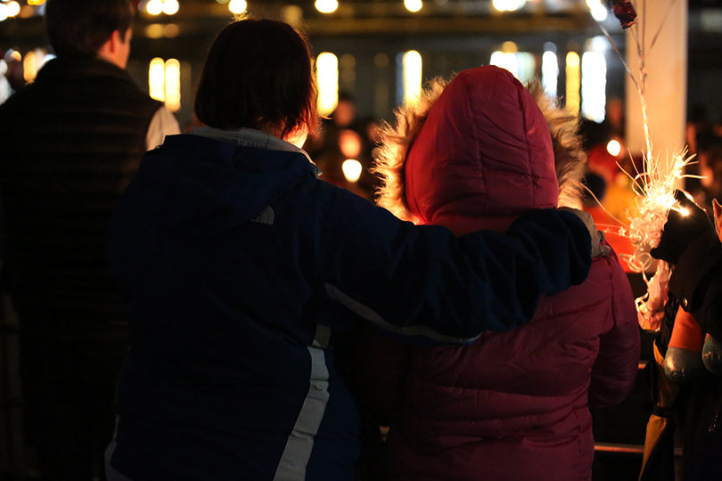 One attendee puts an arm around another at Wednesday's vigil.