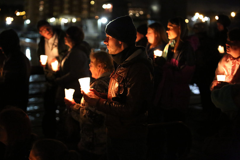 Community members hold their candles at Wednesday's vigil.