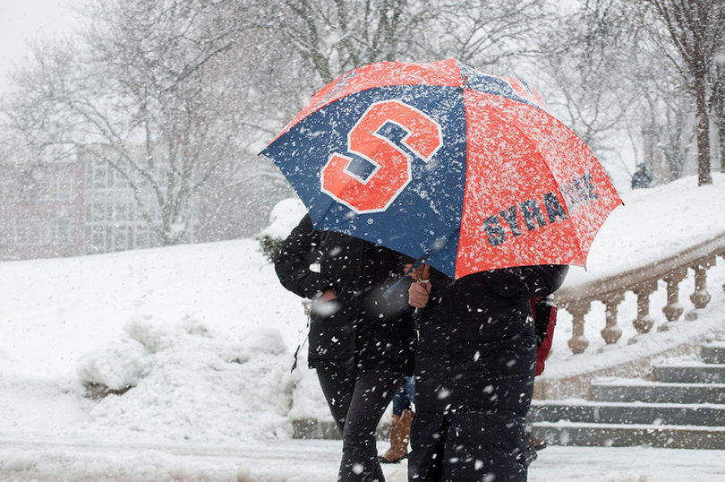 Students use an umbrella to brave Tuesday's weather. 