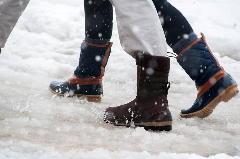 Students walk through the snow on Tuesday.