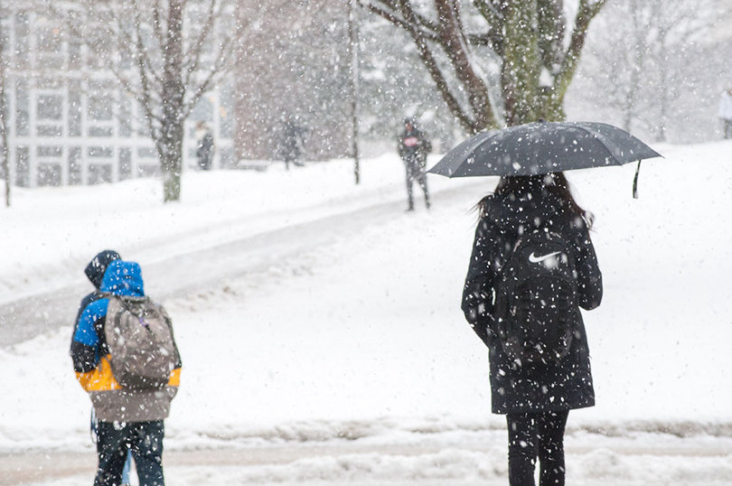 Students walk through the wintry weather on Tuesday.