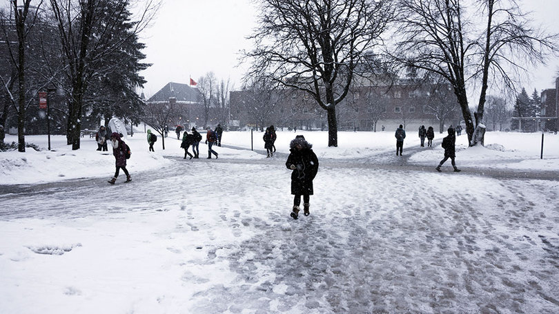 Students walk across the Quad, full of snow and ice, on Tuesday. 