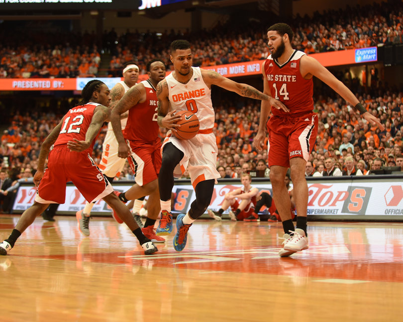 Gbinije drives to the hoop past Barber. The Syracuse point guard made 3-of-5 shots inside the 3-point arc Saturday. 