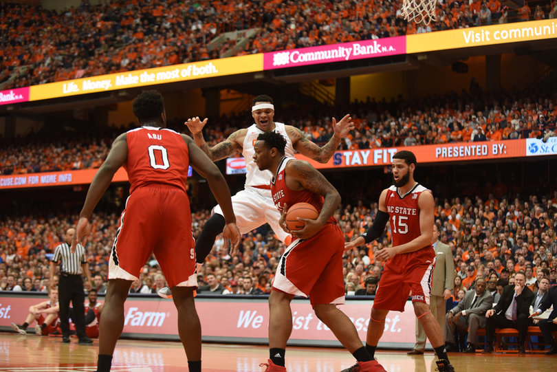 BeeJay Anya grabs a rebound for North Carolina State as Coleman lands on the court. Anya scored seven points and grabbed seven boards. 