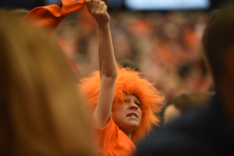 A Syracuse fan dons an orange wig as he cheers on SU.  