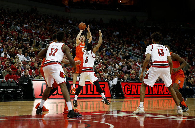 Lewis challenges Cooney's 3-pointer during the first half of Syracuse's matchup with Louisville. Cooney scored 19 points and shot 5-of-10 from 3. 
