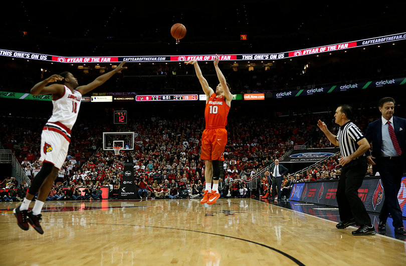 Cooney launches a 3 as a Louisville defender attempts to challenge the Syracuse guard's shot. 