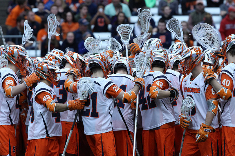 Syracuse huddles up during a stoppage in play. 