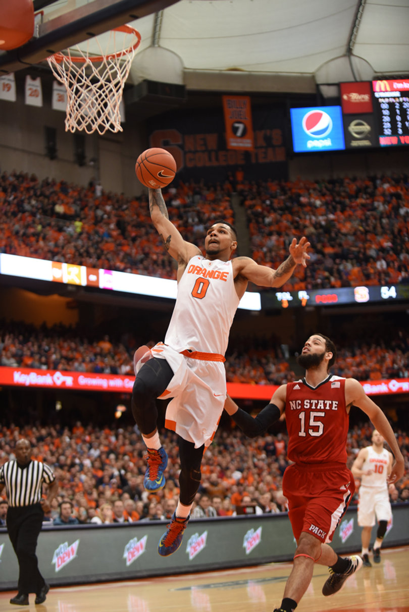 Gbinije leaps for a dunk against N.C. State. He passed the 1,000-point mark during his Syracuse career Saturday.