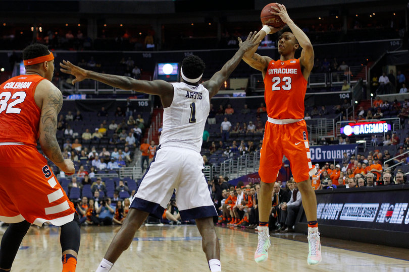 Malachi Richardson jumps to attempt a long shot. Pittsburgh's Jamel Artis lunges toward Richardson to defend him.