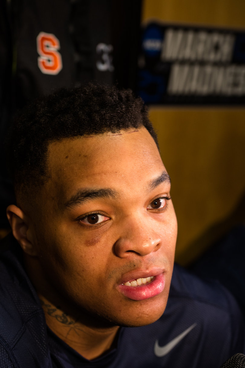Syracuse center Dajuan Coleman speaks with the media in the team's locker room at Scottrade Arena.
