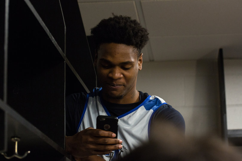 Aldonis Foote takes a picture of a player getting interviewed on Saturday afternoon. 