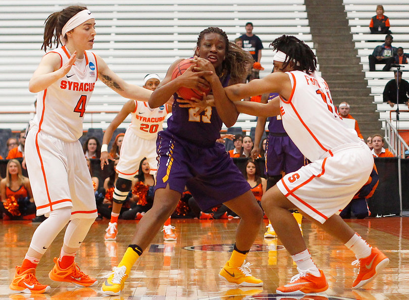 Maggie Morrison and Cornelia Fondren try to wrestle the ball out of the hands of Albany's Zakiya Saunders during the first half of the game. 