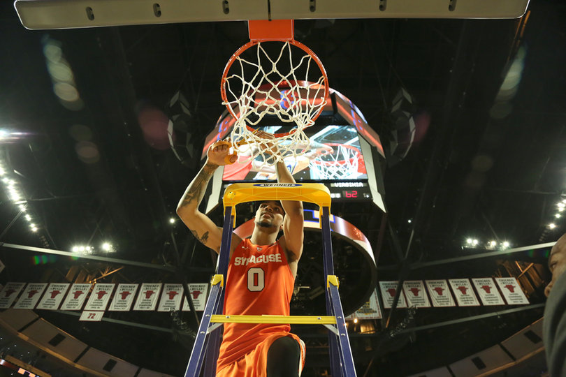 Gbinije cuts down the net in the United Center following the SU win.