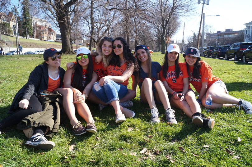 A group of SU students sit on the grass in Walnut Park on Sunday.