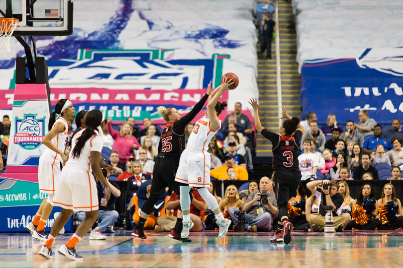 Brianna Butler contends with multiple N.C. State players while holding the ball above her head. Butler finished the game with 17 points.