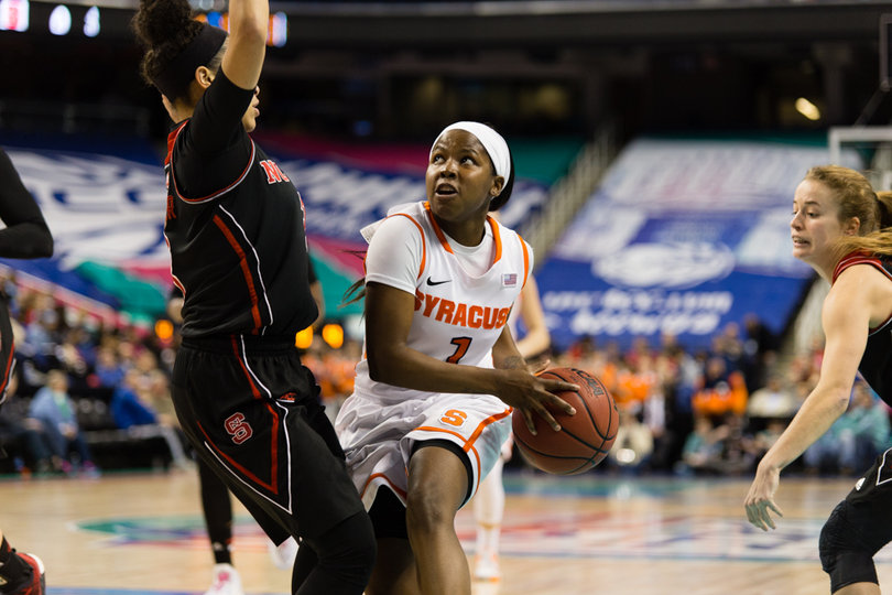 Peterson secures the ball with two hands as a Wolfpack defender stands in her way.