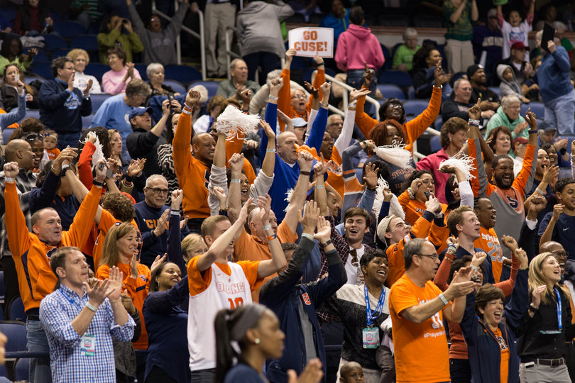 A group of Syracuse fans in the crowd cheer at Greensboro Coliseum in Greensboro, North Carolina.