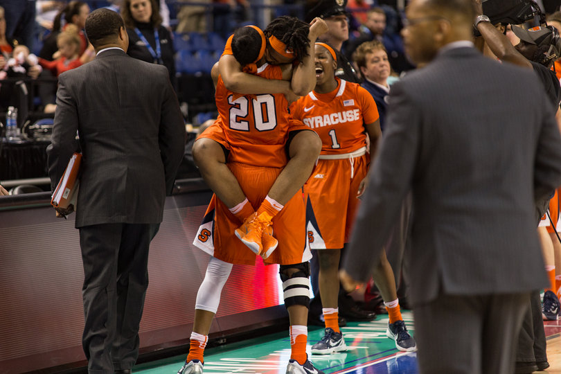 Fondren jumps Sykes arms just after the final buzzer to celebrate the upset over Louisville. 