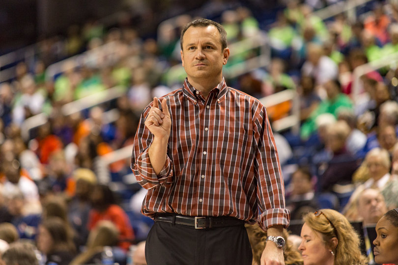 Louisville head coach Jeff Walz questions a referee's call after one of his players was called for stepping out of bounds.