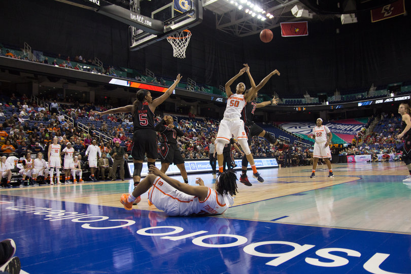 Briana Day reaches for a rebound as Fondren lies on her back underneath the hoop. Day had eight rebounds in Syracuse's win.
