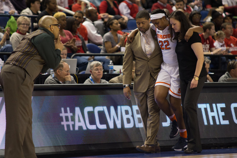 After rolling her ankle, Taylor Ford limps off the court with the help of assistant coach Cedric Solice and associate athletic trainer Karen McKinney after. Her status for Saturday's game against Louisville is uncertain.