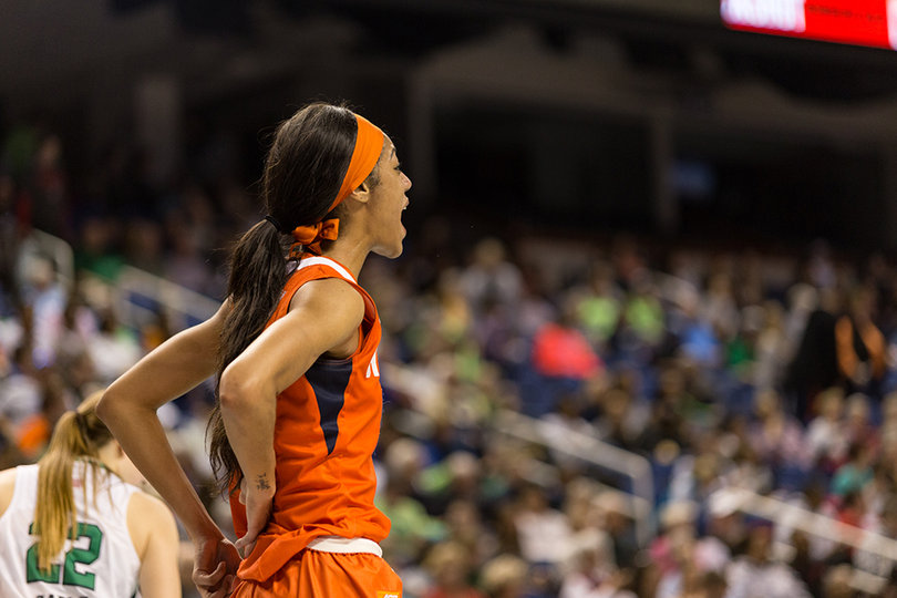 Briana Day stretches her arms behind her back as she looks onward at the Greensboro Coliseum court in the ACC tournament championship.