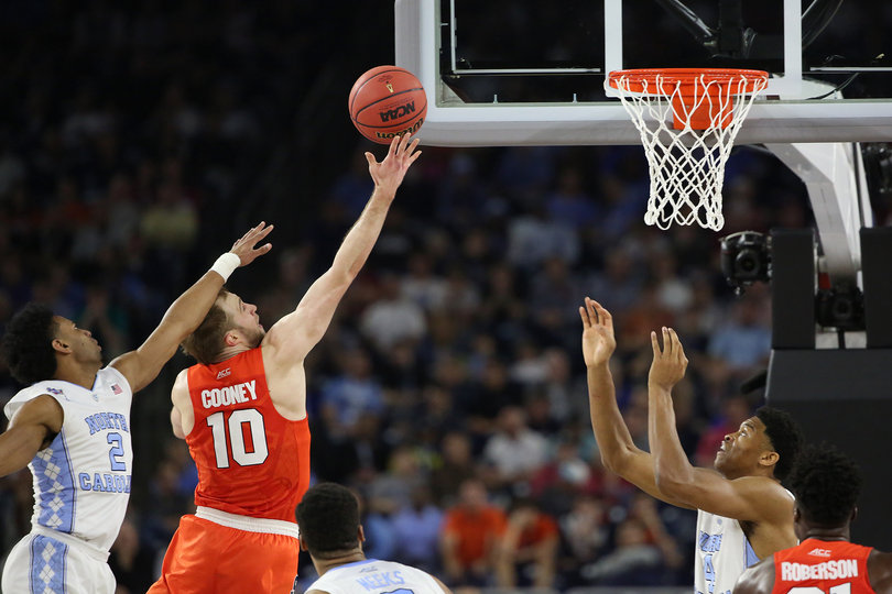 Trevor Cooney lays up a shot after beating Joel Berry II (2). Cooney scored 22 points and shot 9-of-18 from the floor. 