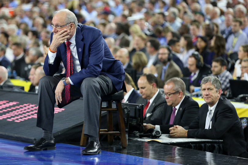 Boeheim cups his hand  around his face while watching his Syracuse team take on North Carolina. 