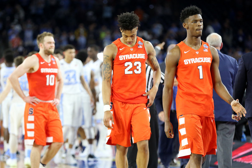 Cooney, Richardson and Frank Howard (1) walk off the court during Saturday's matchup against North Carolina. 