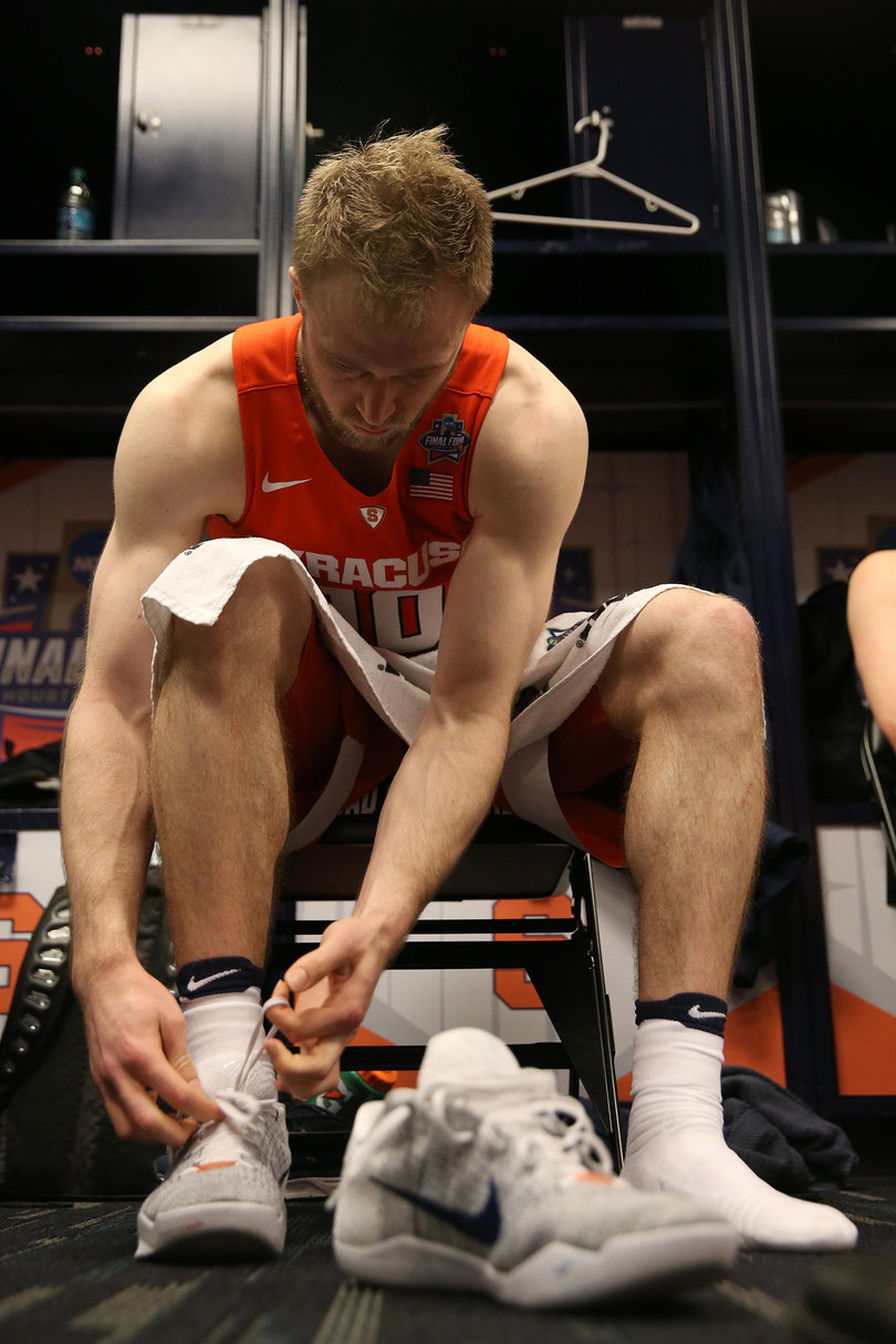 Cooney unties his shoelaces after Syracuse's 83-66 loss to North Carolina. 