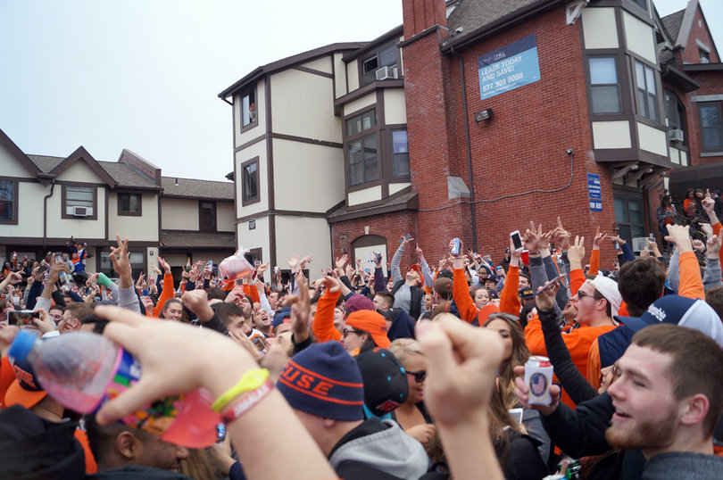 Students throw their hands in the air to the beat of the music.